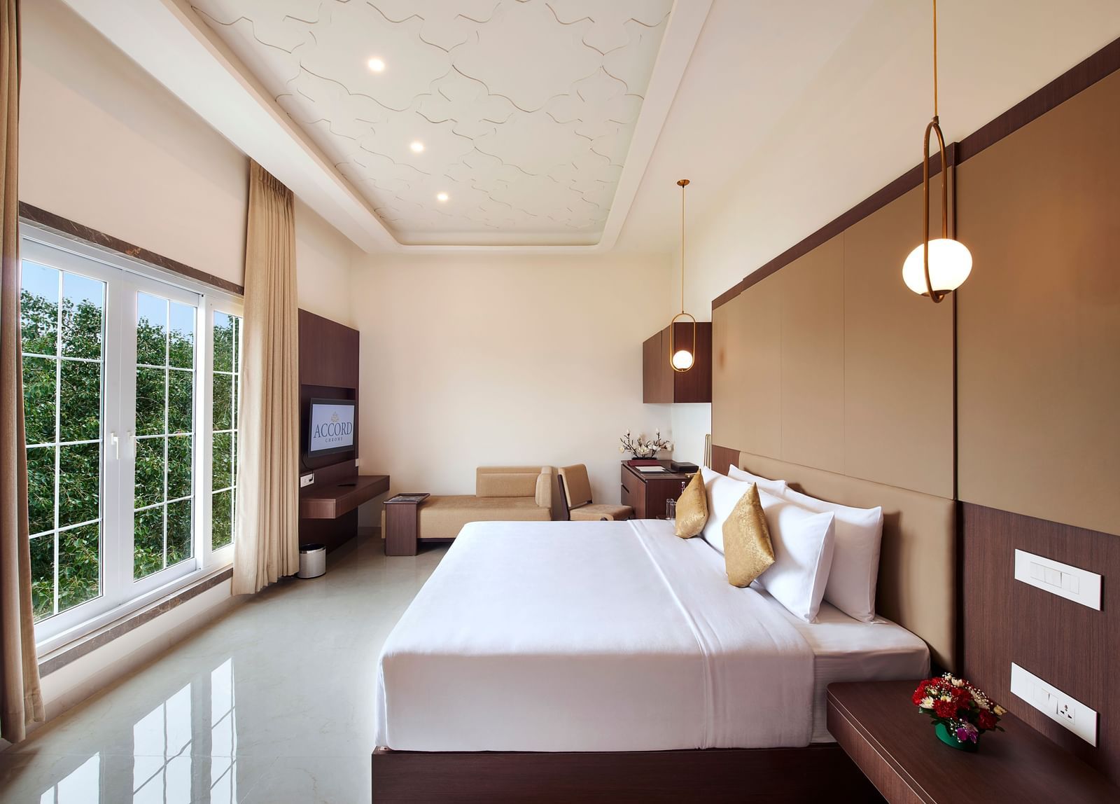 A hotel room with a bed placed in front of giant french windows - Accord Chrome Airport Hotel